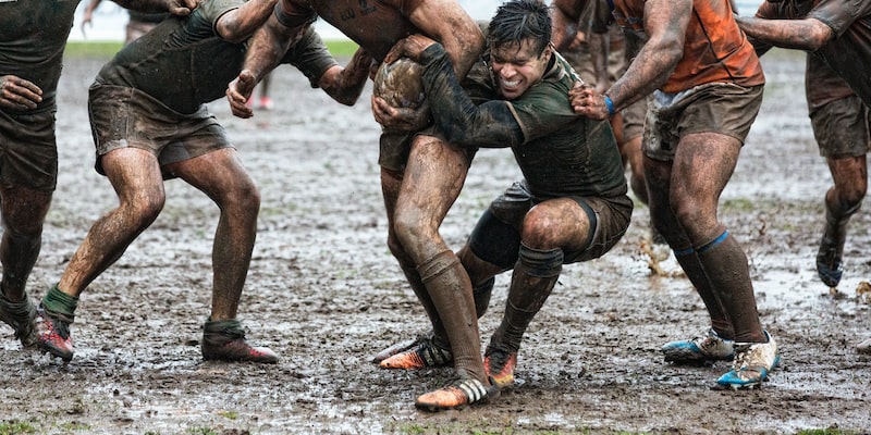 In rugby, what exactly happens after the ball carrier is tackled?